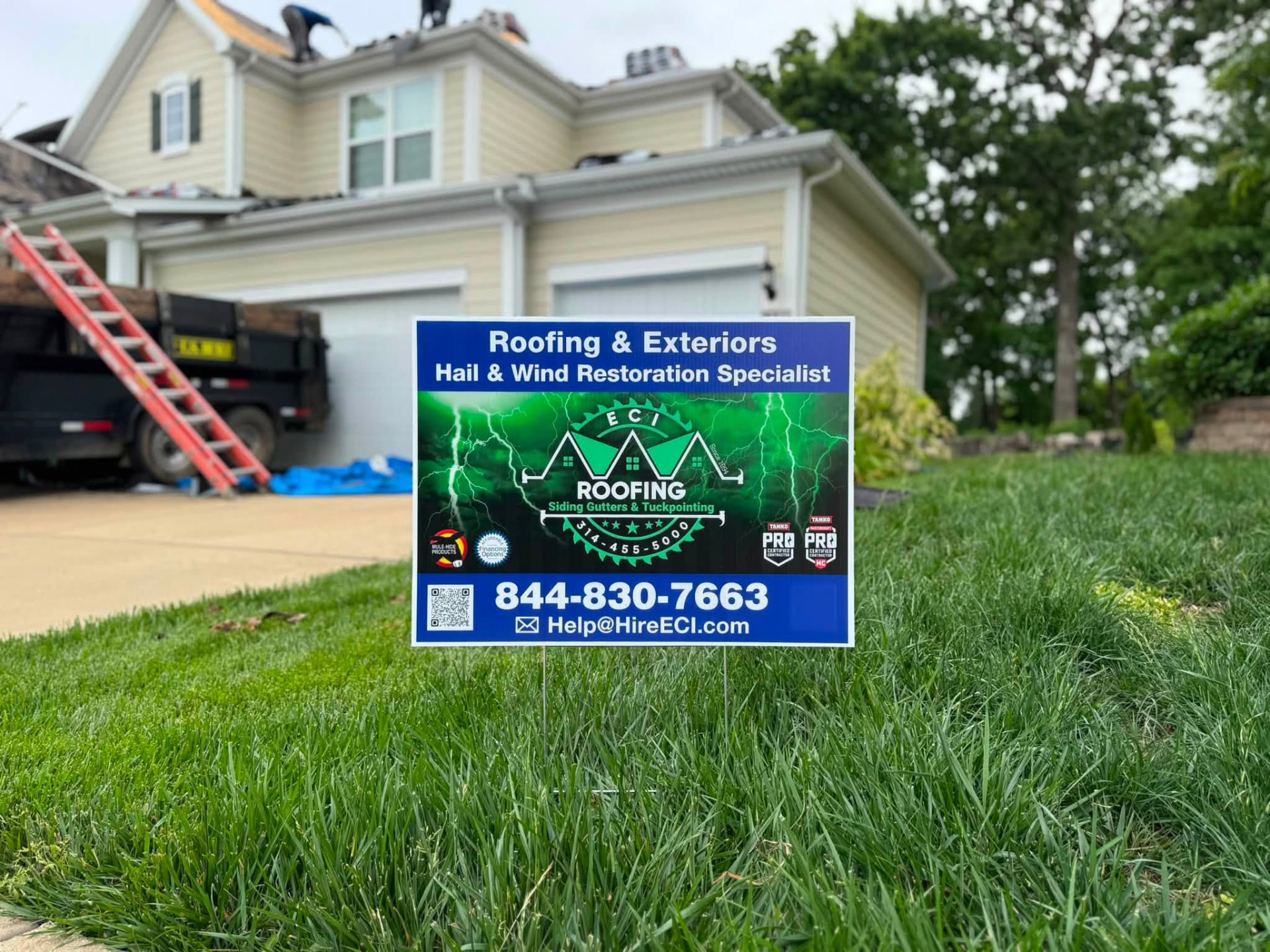 ECI yard sign beside our truck and ladder at a Missouri roofing job